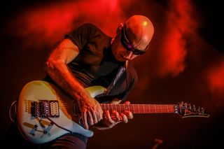 Joe Satriani perfoming with one of his signature Ibanez JS2480 guitars.
