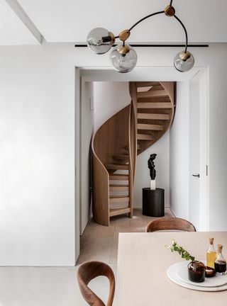 White modern room with wood spiral staircase