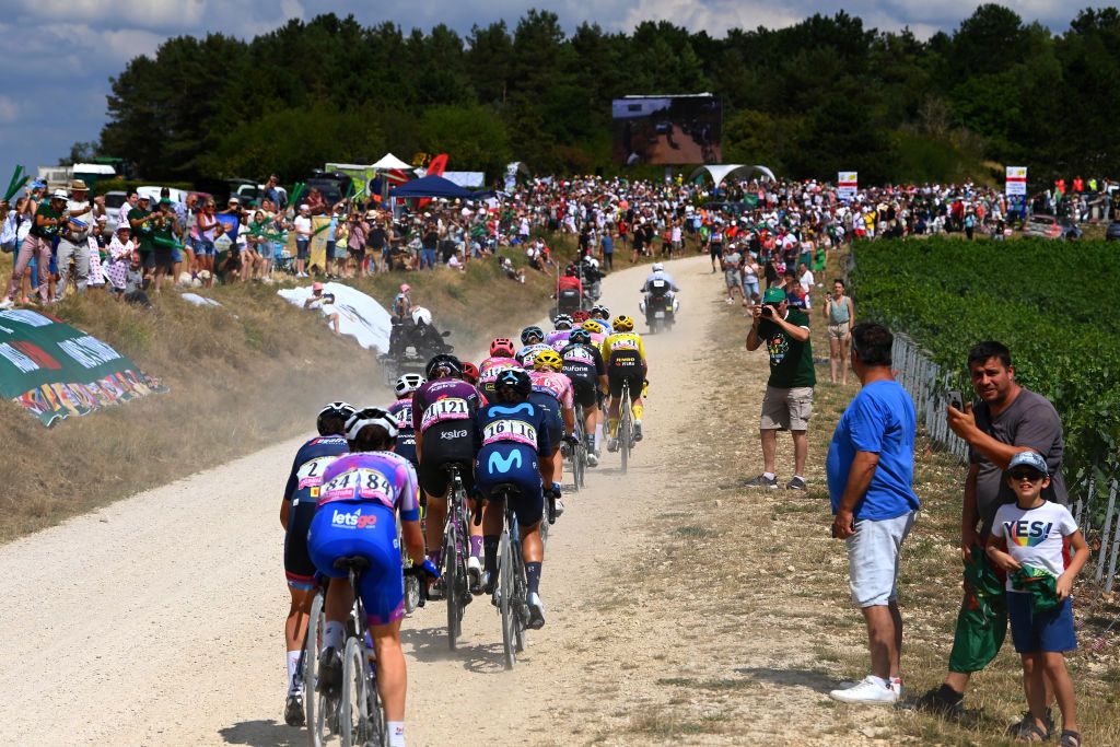 BARSURAUBE FRANCE JULY 27 A general view of Ruby RosemanGannon of Australia and Team Bikeexchange Jayco Jeanne Korevaar of Netherlands and Team Liv Racing Xstra Arlenis Sierra Caadilla of Cuba and Movistar Team Alena Amialiusik of Belarus and Team CanyonSRAM Racing Juliette Labous of France and Team DSM Women and Marianne Vos of Netherlands and Jumbo Visma Women Team yellow leader jersey compete through gravel roads while fans cheer during the 1st Tour de France Femmes 2022 Stage 4 a 1268km stage from Troyes to BarSurAube TDFF UCIWWT on July 27 2022 in BarsurAube France Photo by Tim de WaeleGetty Images