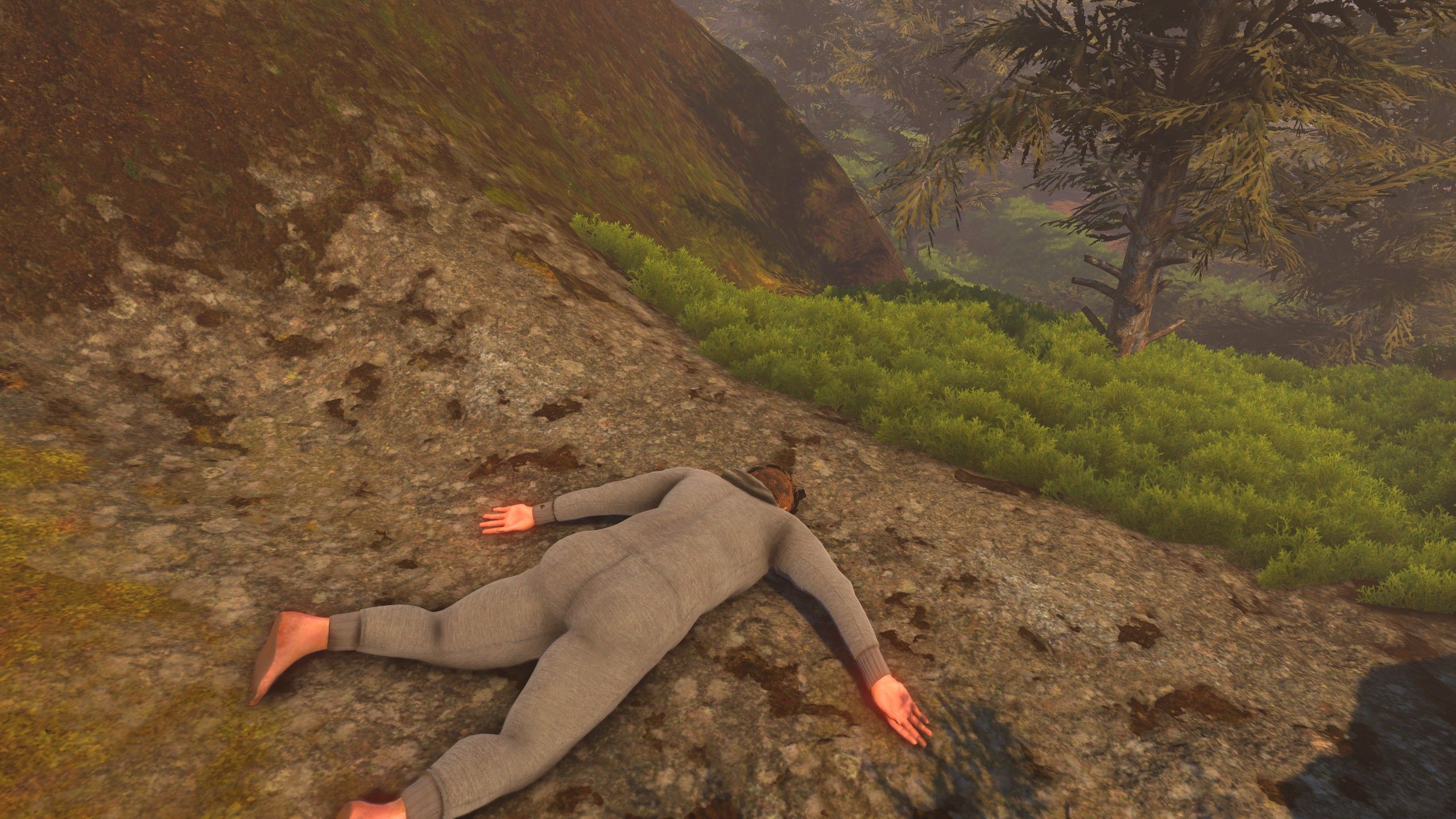 Nate lies on his face on the rocks