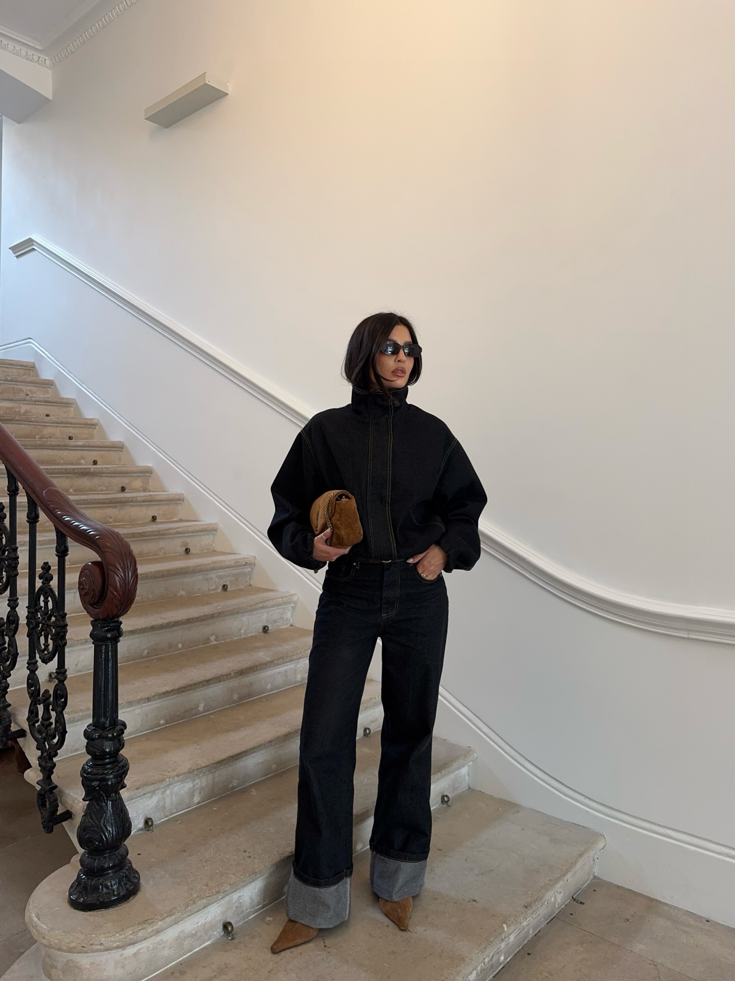 A woman wearing fall boot trend with jeans in 2026.