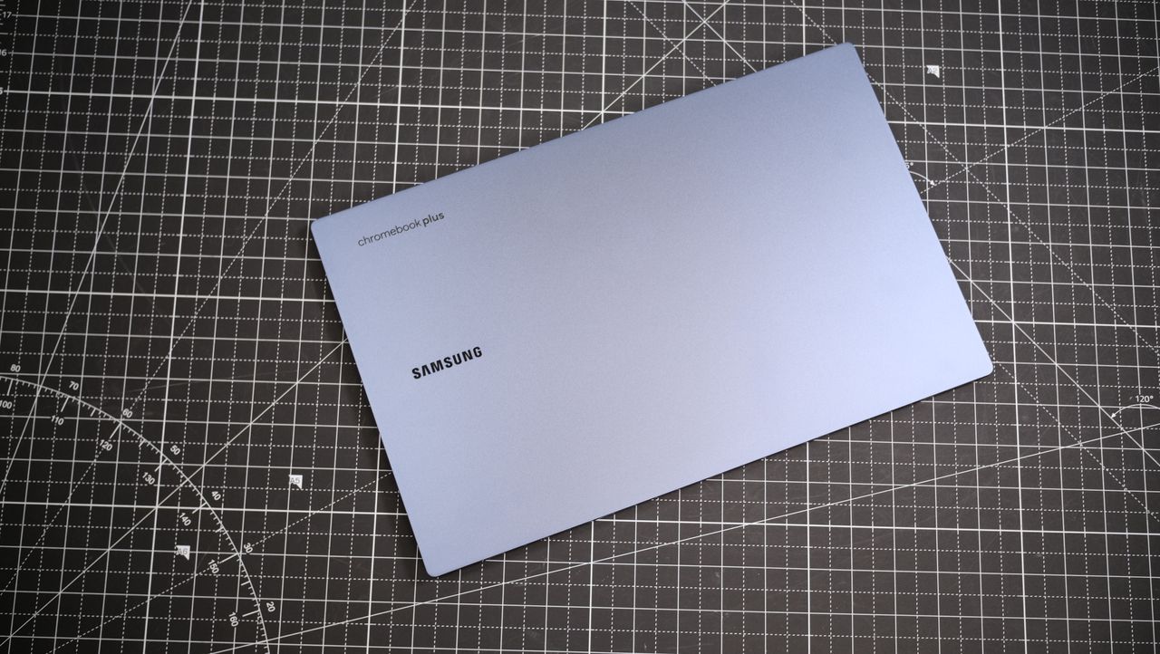 Top-down view of the cover of the Samsung Galaxy Chromebook Plus against a black and white table mat.