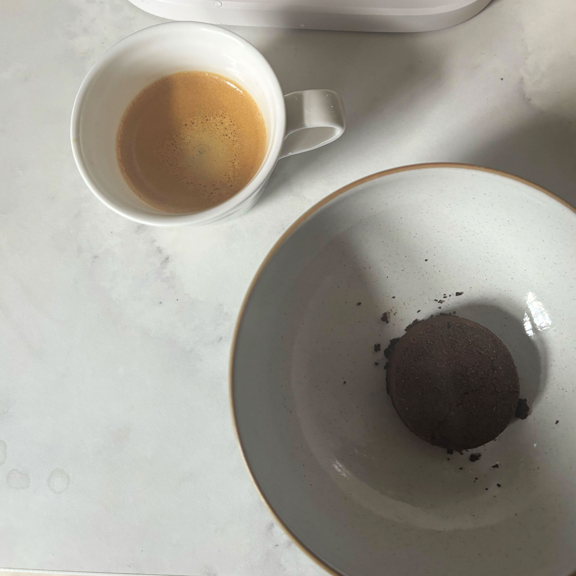 White Philips Baristina a espresso cup and a bowl with a coffee puck in