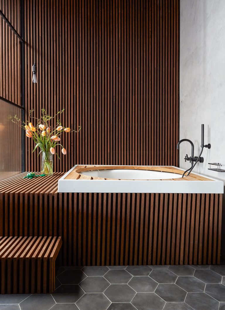 Wooden panelled bathroom with circular bath
