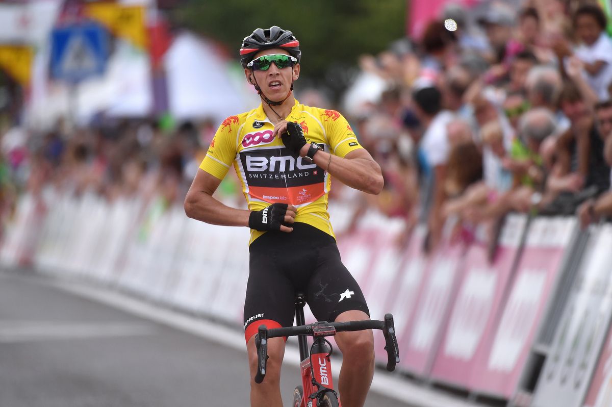 Dylan Teuns (BMC Racing) zips up the jersey before celebrating