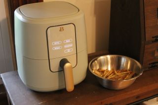 Beautiful 6-Quart Digital Air Fryer next to a bowl of fresh french fries