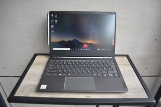 The Lenovo ThinkBook Plus on wooden desk