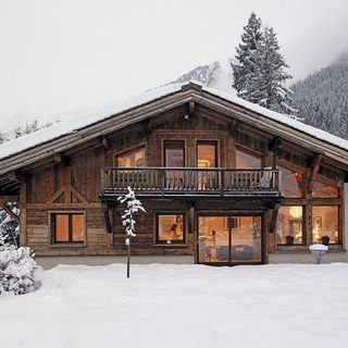 house exterior with wooden house and snow