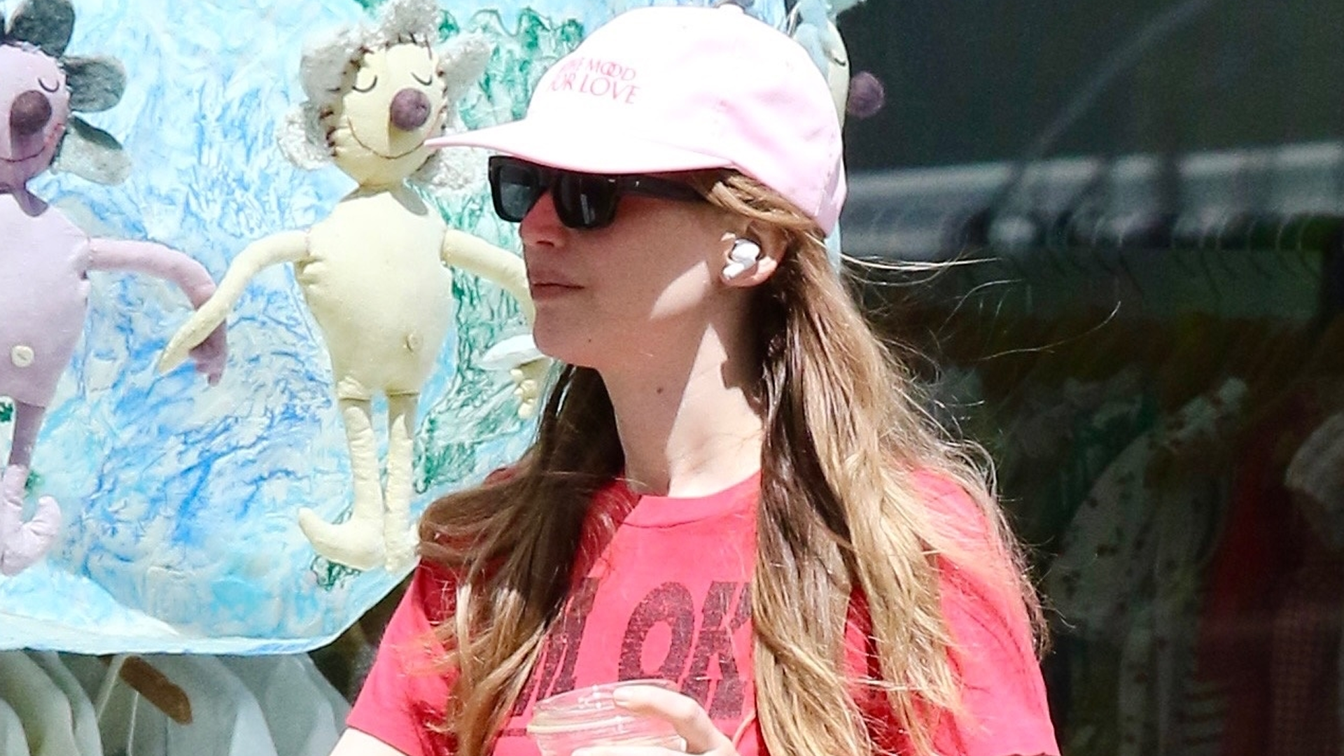 Jennifer Lawrence wore the strawberry red and peony pink color trends with dad sandals for summer