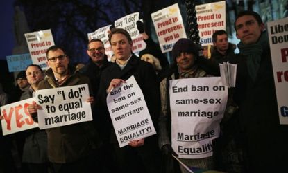 Gay rights campaigners gather outside The Houses of Parliament on Feb. 5 in London.