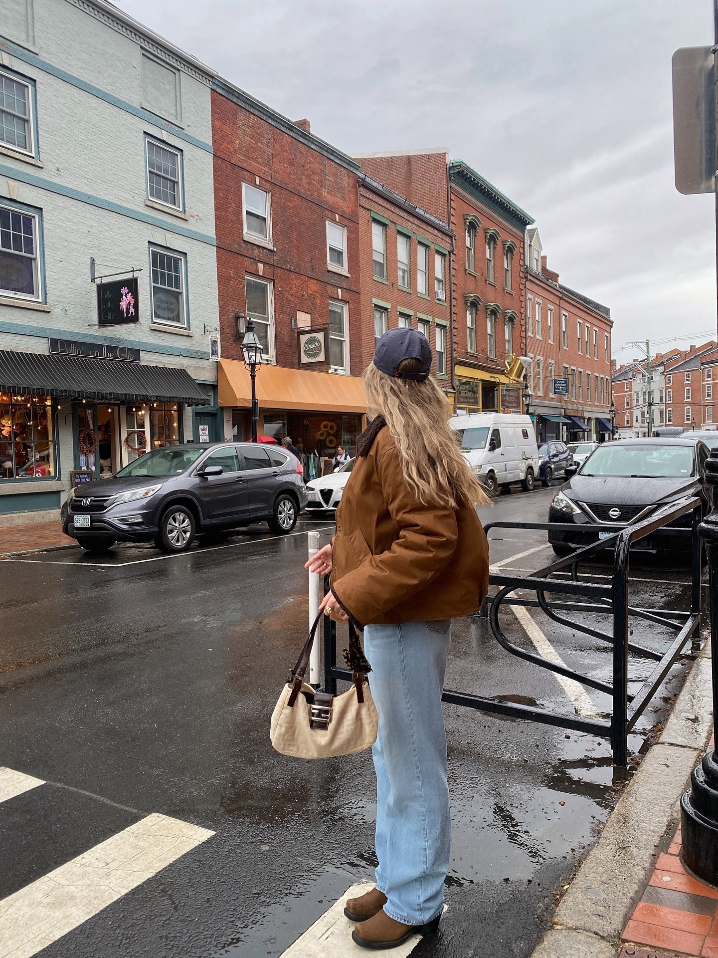 Creator @michellerosedrumm wearing an autumnal outfit in the rain