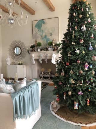 elegant farmhouse sitting room dressed for christmas with tree with tree skirt