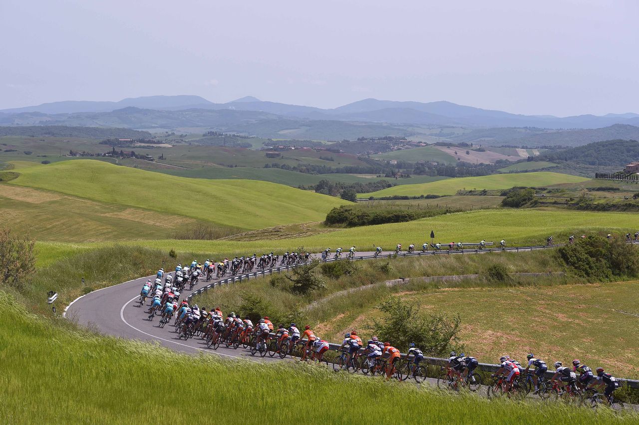 The peloton passes through the Toscana landscape