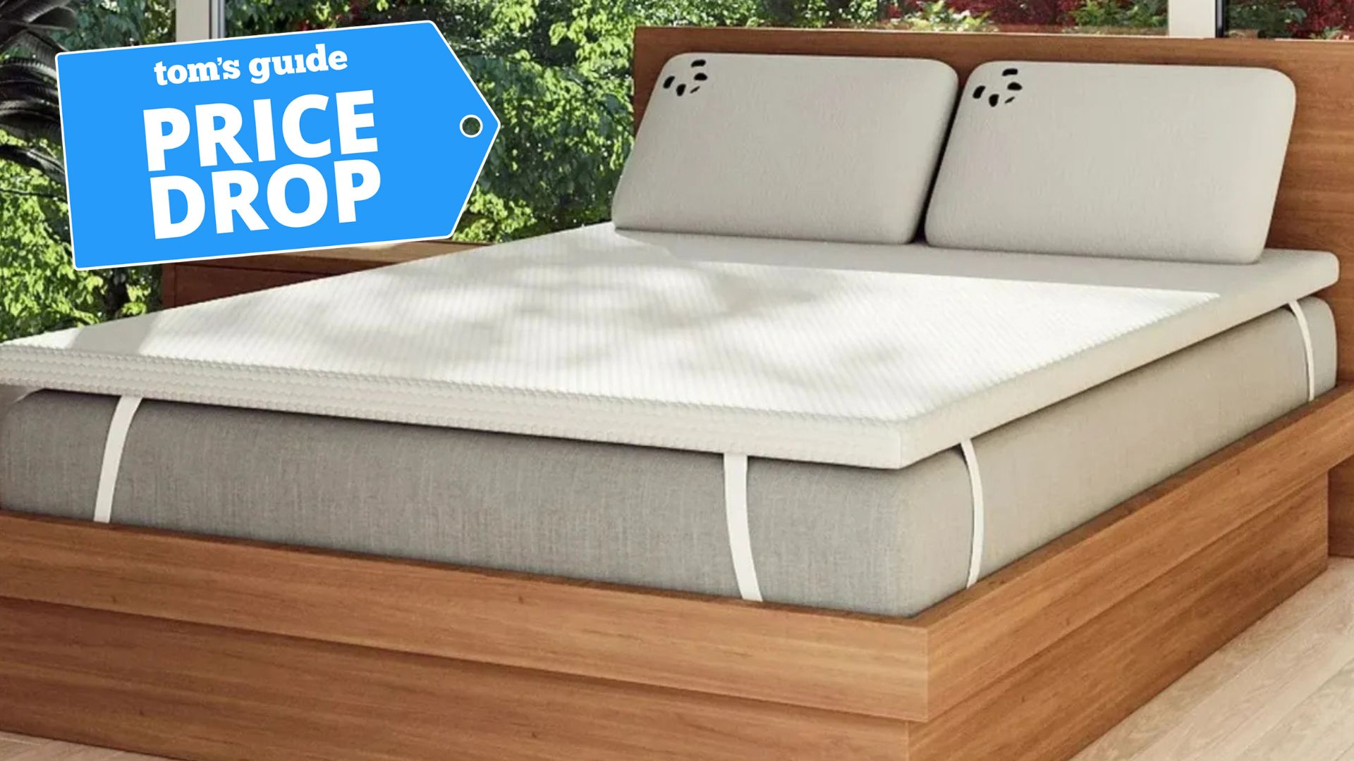 The Panda London Bamboo Mattress Topper on a mattress. A price drop deals badge is seen in the top left foreground. 