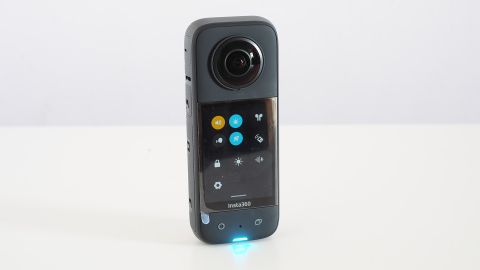 The Insta360 X3 stood on a white desk with the screen showing