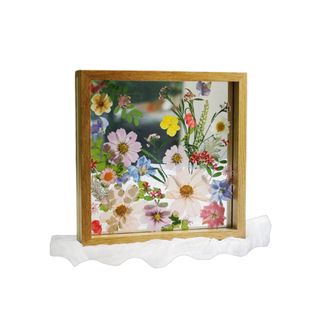 A wooden frame with dried flowers in it