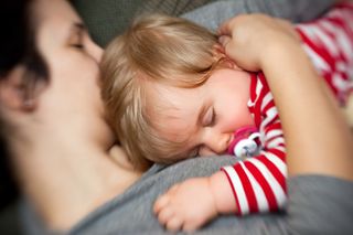 newborn baby sleeping with mom