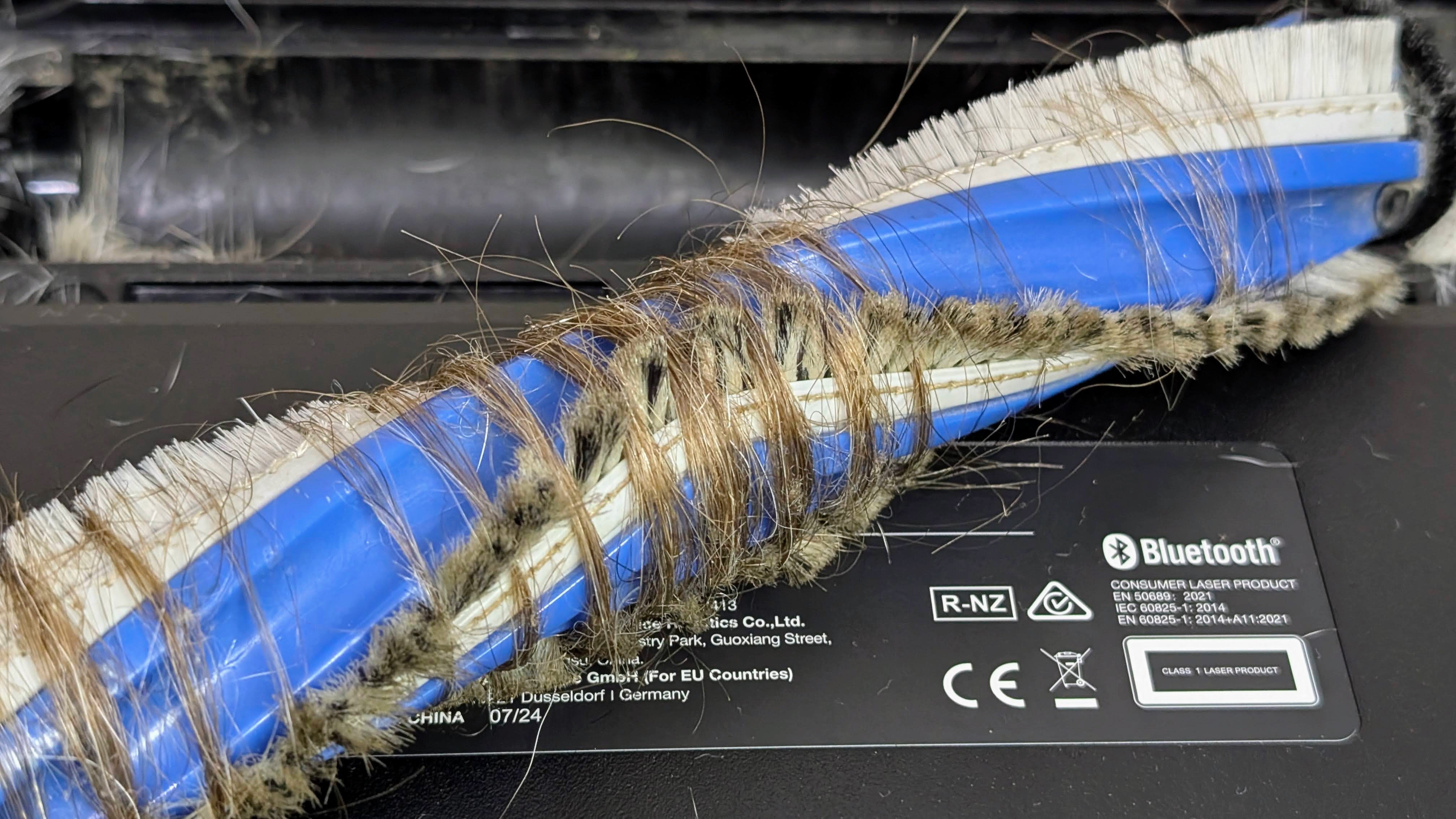 Ecovacs X5 Pro Omni robovac main brush showing tangled hair