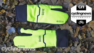 Pair of Gore-Tex Infinium Split gloves on a leafy ground, with cyclingnews 'recommends' badge overlaid