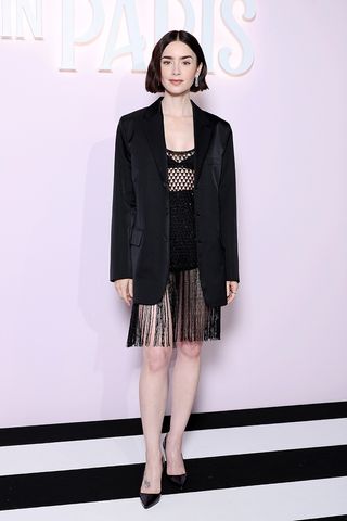 Lily Collins wearing a blazer and fringed dress