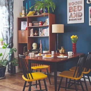 Blue-painted dining room with mid-century modern furniture