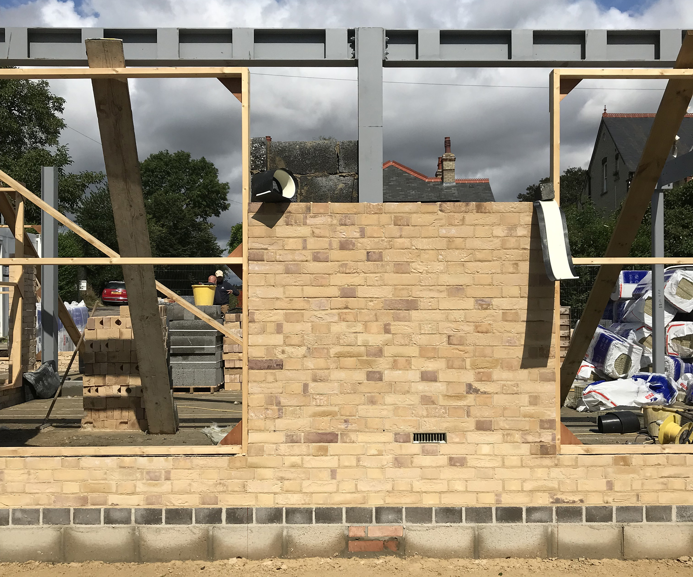 A home under construction with bricks and space for glazing