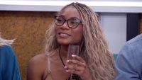 Taylor Brown holding a champagne glass in Big Brother