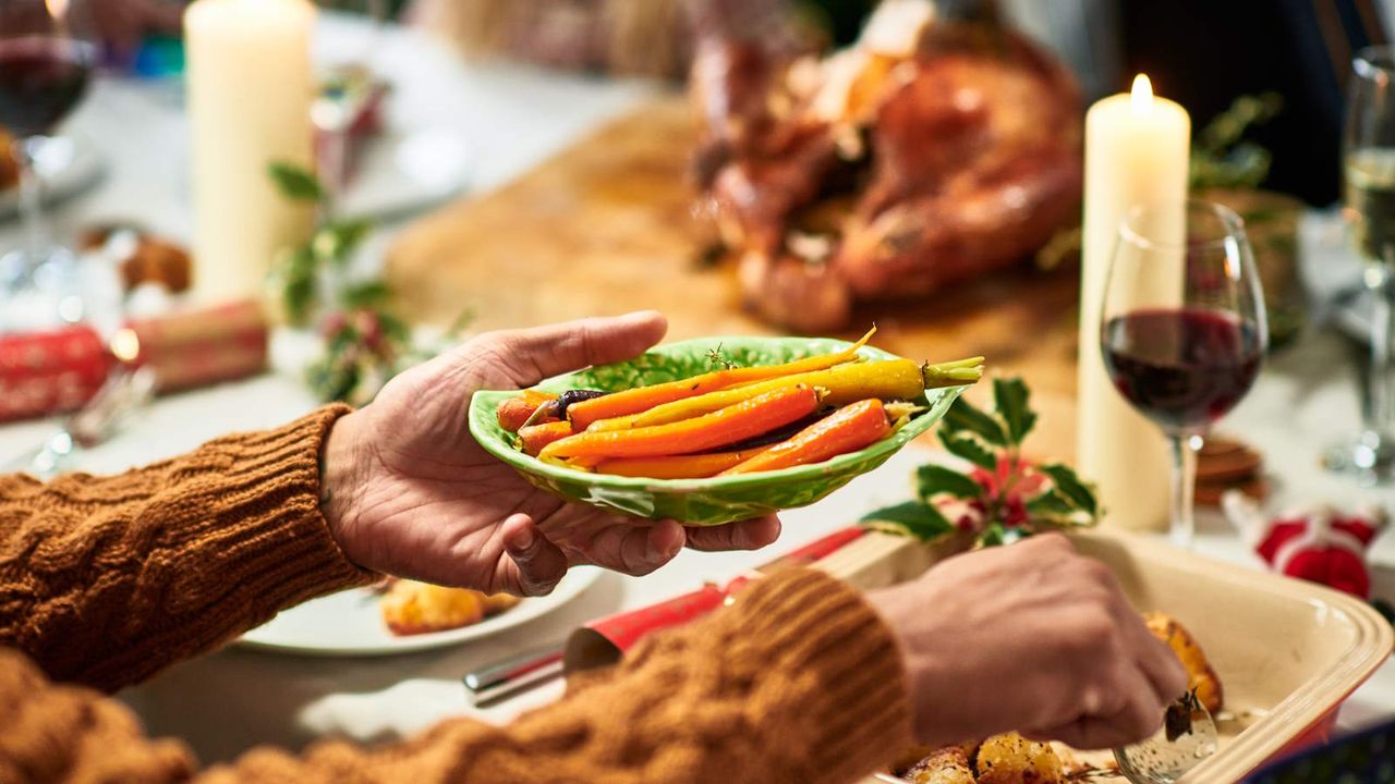 Carrots being served for Christmas dinner with a turkey on the table 