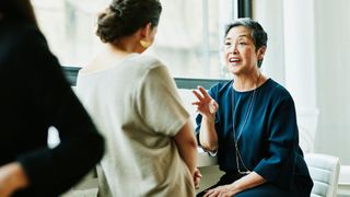 Woman giving another woman a compliment