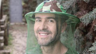explorer wearing anti mosquito net hat