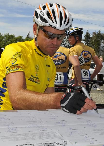 Tour leader Jeremy Yates of Share the Road signs in before the start of stage five.