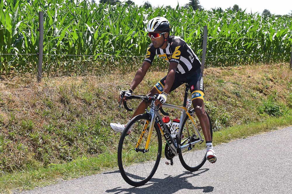Kudus Ghebremedhin (MTN-Qhubeka) waits for the team car to service a puncture.
