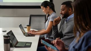 Employees working on laptops