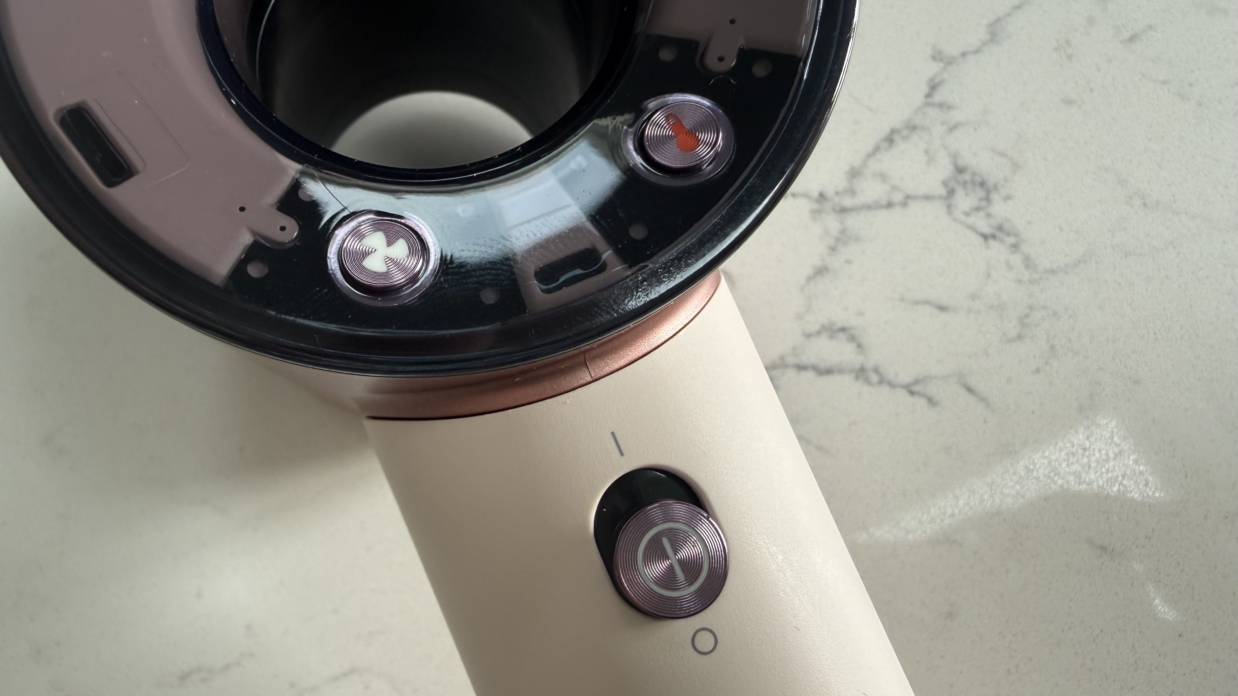 Close-up of the Dyson Supersonic Travel hair dryer power switch and control buttons