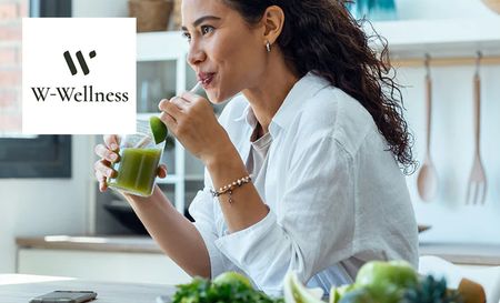 Woman drinking W-Wellness supplements for her daily nutrients