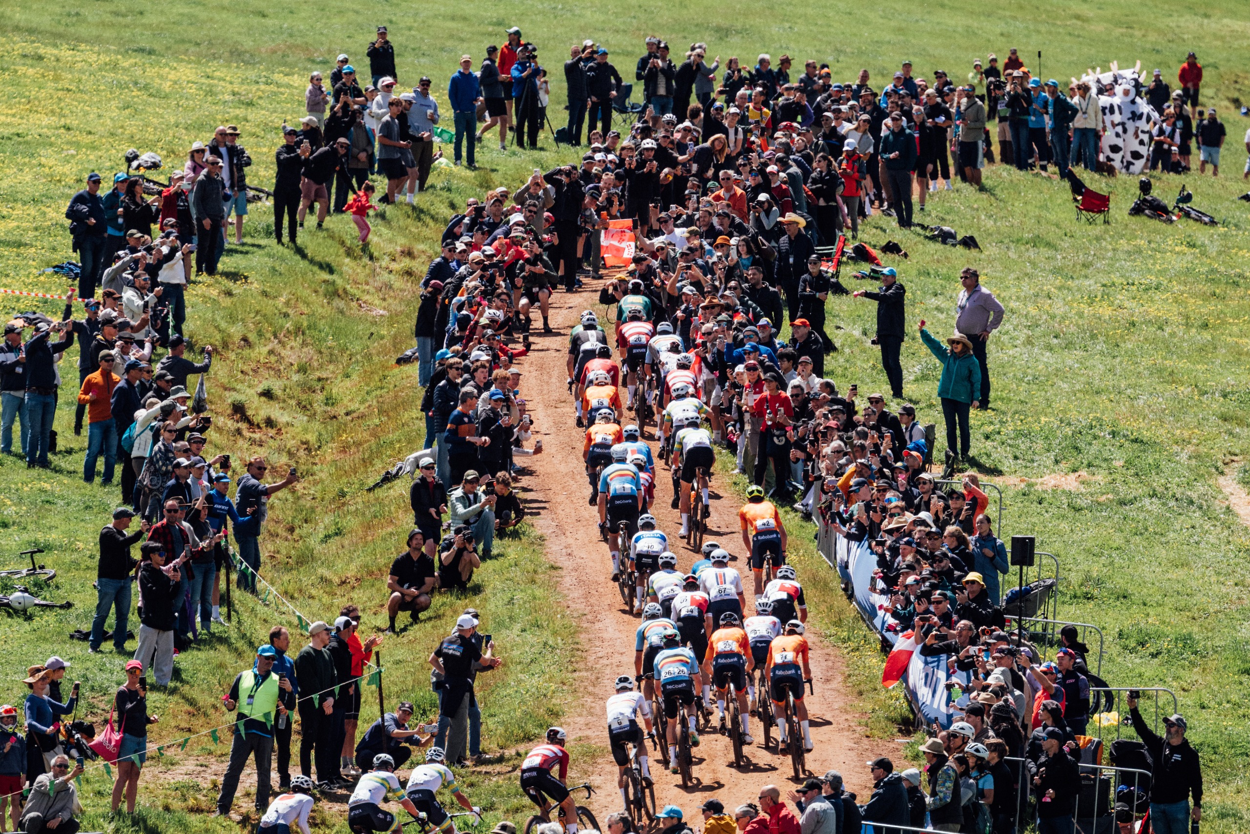The peloton rides through crowds of fans during the 2026 UCI Gravel World Championships in Nannup, Western Australia, Australia