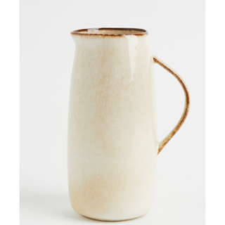 cream and brown stoneware pitcher