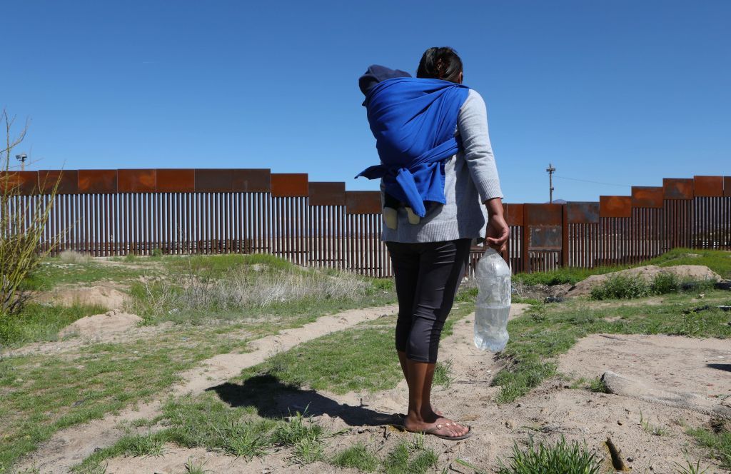 A migrant and their child at the U.S.-Mexico border.