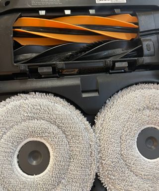 Underside of the Dreame X50 Ultra robot vacuum revealing mop pads and dual brushrolls