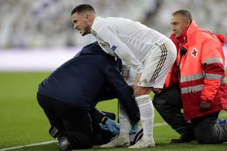 Real Madrid’s Eden Hazard receives treatment