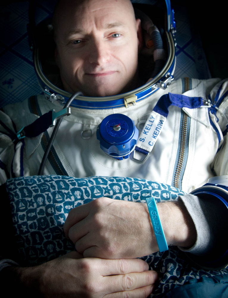 Expedition 26 Commander Scott Kelly wears a blue wrist band that has a peace symbol, a heart and the word &quot;Gabby&quot; to show his love of his sister-in-law U.S. Rep. Gabrielle Giffords as he rest onboard a Russian Search and Rescue helicopter shortly after he