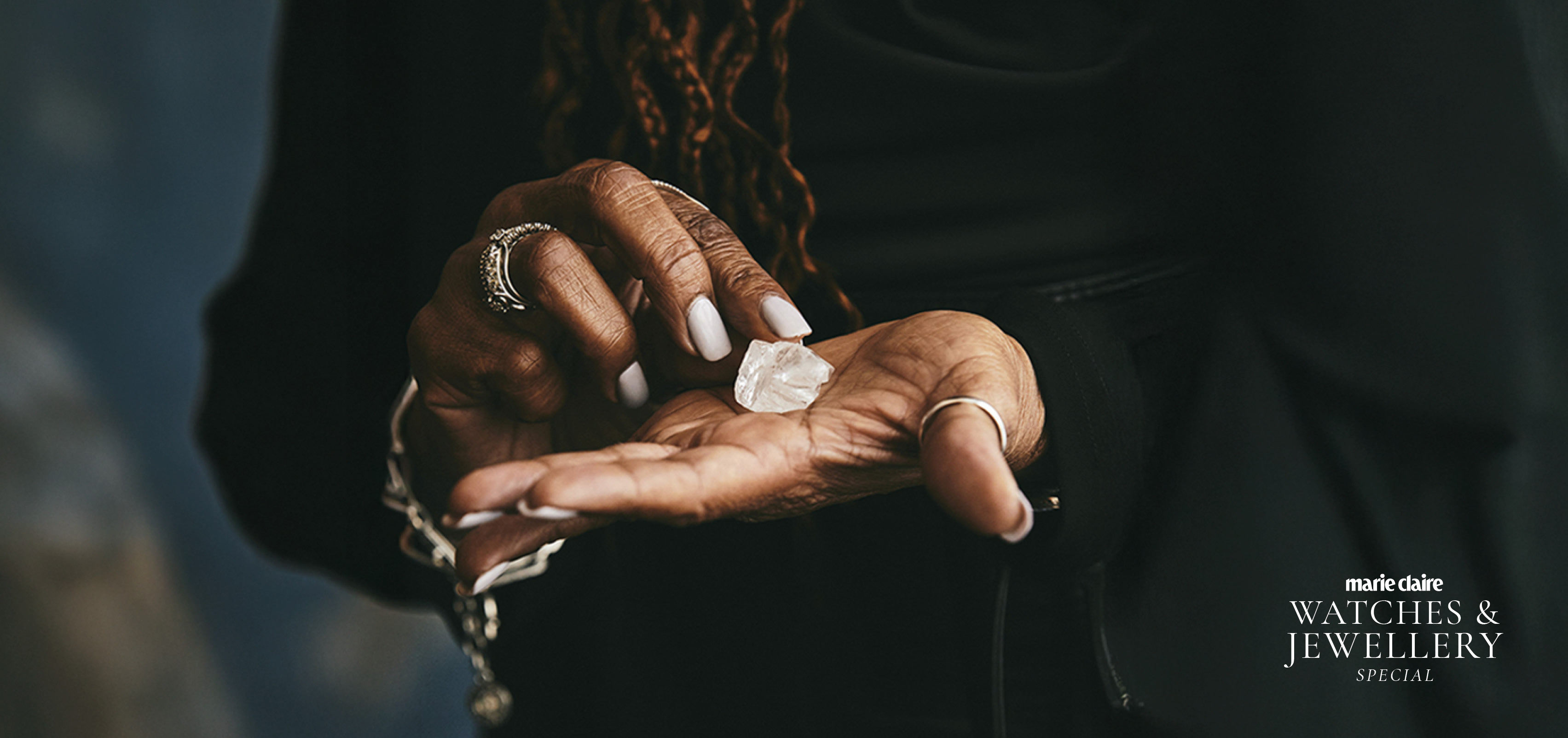 An image of a woman's hand holding a natural diamond