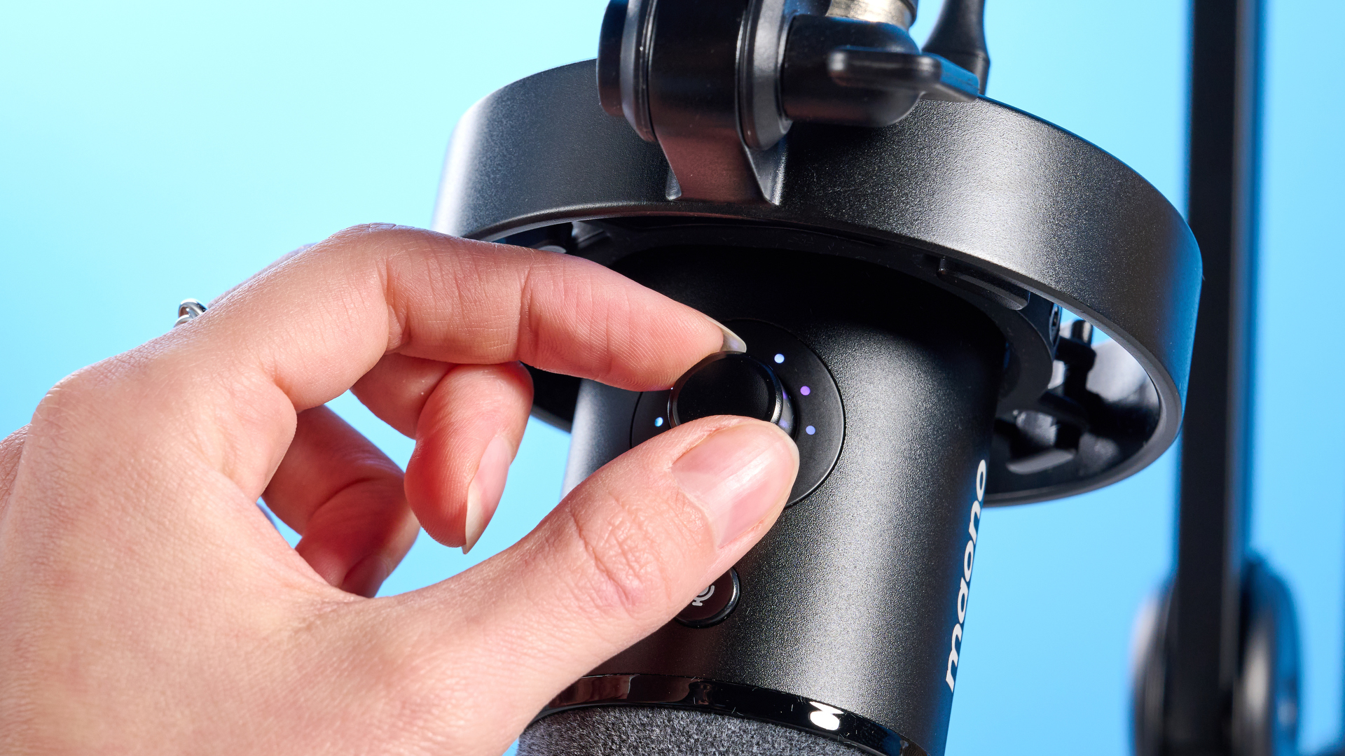 the maono pd1300x microphone for podcasting with an xlr and usbc connection and a boom arm in the photograph but also available with a desktop stand, one button dial on the mic and a muting button