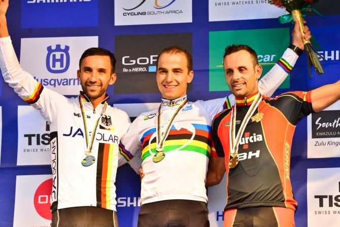 From left to right: Germany's Manuel Fumic (third), Switzerland's Nino Schurter (first) and Jos&eacute; Hermida Ramos (second) enjoy the moment after finishing on the podium in the elite men's cross country