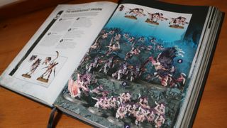 An open Warhammer 40K Leviathan rulebook on a wooden table