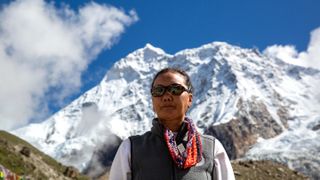 Lhakpa Sherpa photographed in front of a mountain in "Mountain Queen: The Summits of Lhakpa Sherpa" on Netflix