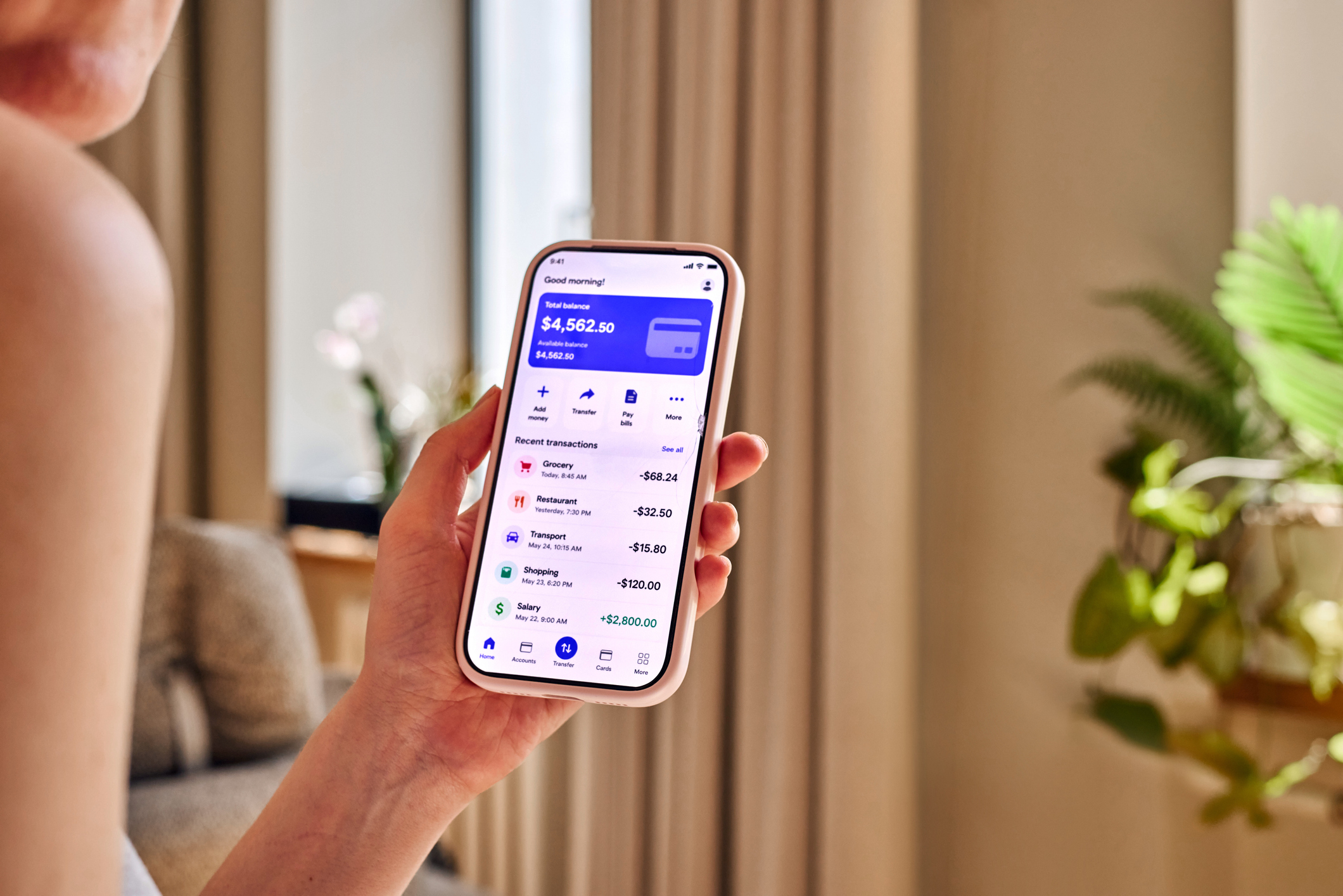 Woman checking Starling Bank savings account on mobile phones
