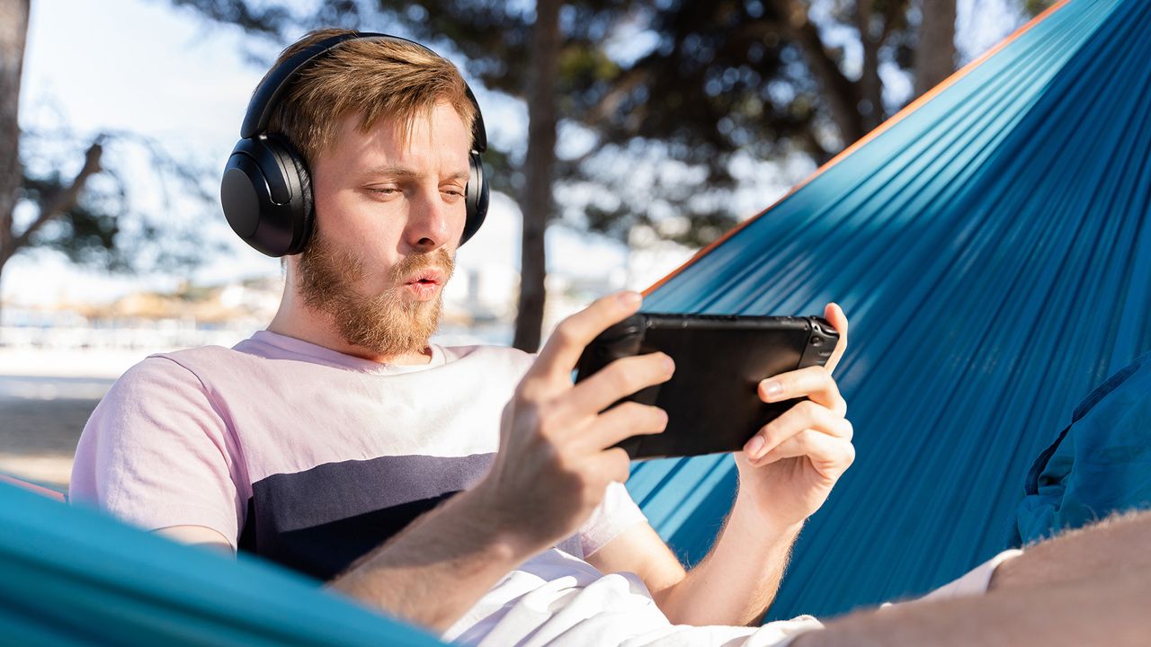 Man playing a gaming handheld