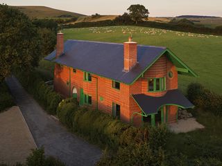 hero aerial of red house in the Dorset countryside