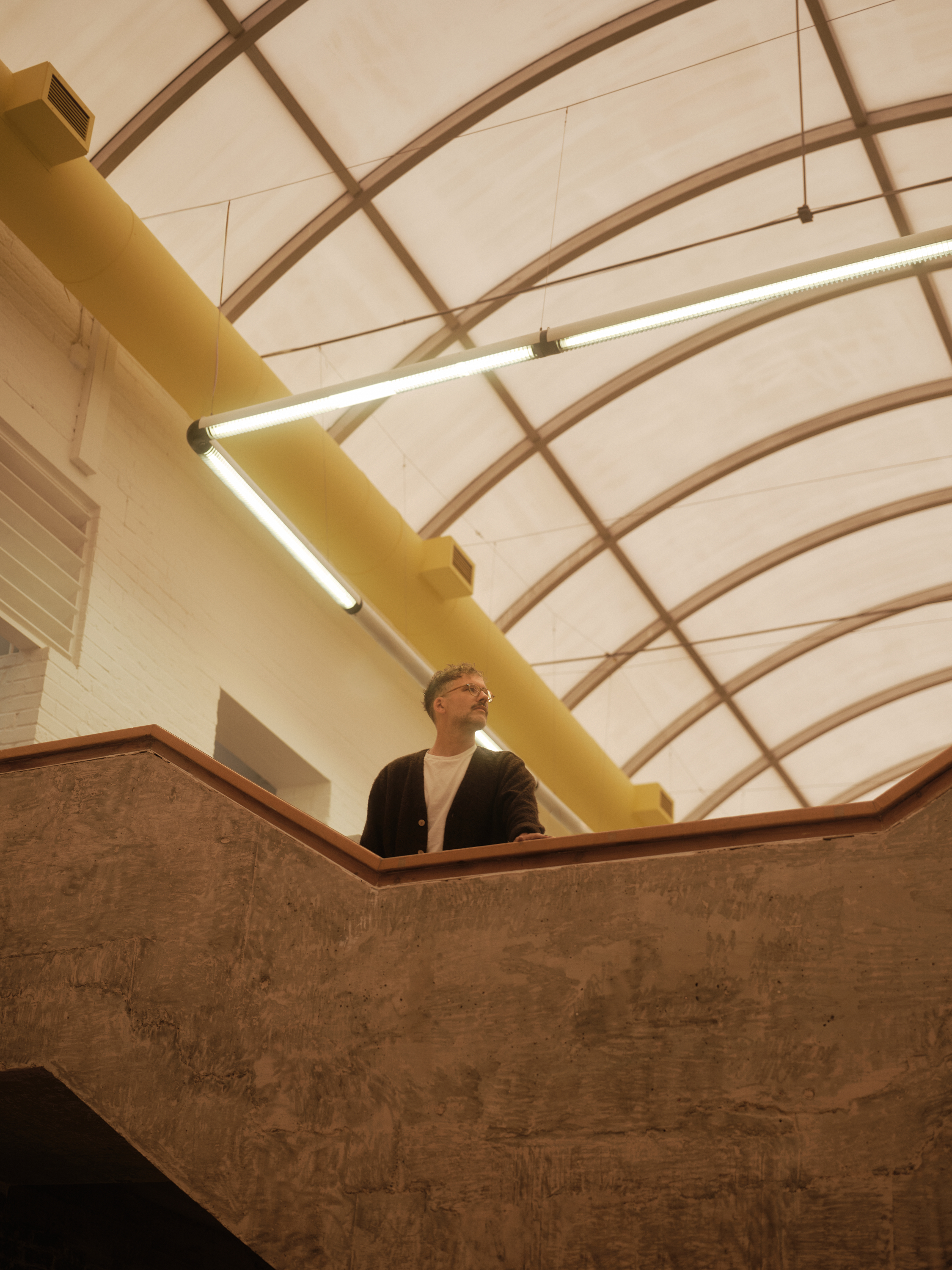 new Cubitts headquarters interior, refurbished warehouse type building with raw materiality and colour pops